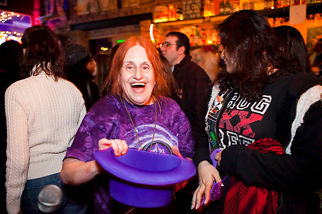 Ilene Richards does her part to help raise money by passing the purple hat around the pub.