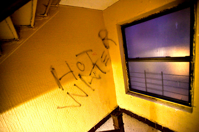 The staircase walls at 2239 Creston Ave. are covered in graffiti requesting hot water.