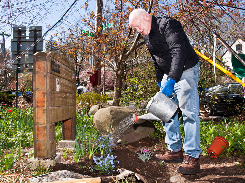 Bob Bowen, 57, above, waters newly planted flowers at Endor Community Garden on Sunday.