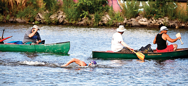 Baron Ambrosia passes by Concrete Park en route to Harding Park on his southward swim in the Bronx River on Saturday.