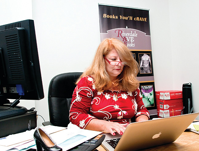 Lorie Perkins, publisher of Riverdale Avenue Books, works in her 5676 Riverdale Ave. office, where the new company publishes erotica, LGBT, horror, science fiction, fantasy, sports and more.