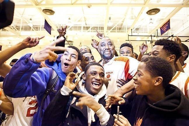 JFK's Johnny Mathis, center, celebrates after winning his 600th basketball game as a coach.
