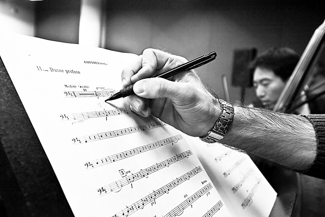 A musician annotates his score.