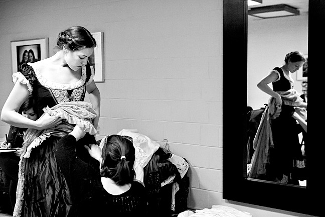 Costume designer Victoria Depew fits a dress for Laura Flaxman, who plays Flora in the show.