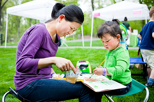 Ying Hung watches her daughter Ellie Lee, 3, paint her surroundings with watercolor paint and supplies provide by The New York Botanical Gardens as part of the Mother’s Day Weekend Garden Party on Saturday.