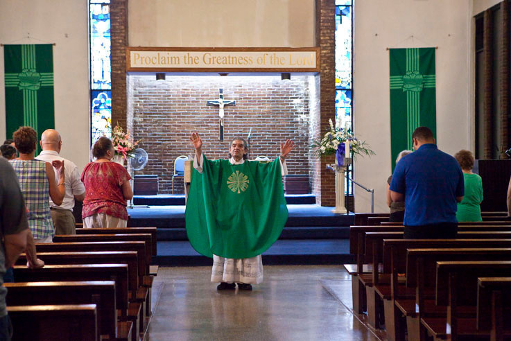 Father James Villa concludes a mass at the Church of the Visitation of the Blessed Virgin Mary in August 2012.