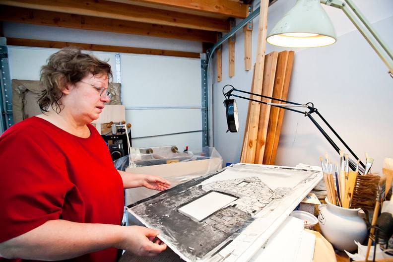 Agnes Murray looks at one of her award-winning monotypes depicting a famous Scottish castle insider her West 259th Street home studio.