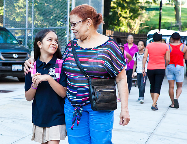 Johanny Rodriguez, 9, gets a hug from her caretaker Antonia Almonte, 75, on the way to the Sheila Mencher School (P.S. 95) on Sept. 4, the first day of school.