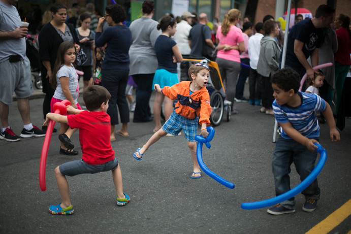 Devin Cuddy, 4, gets in a fighting stance as he play battles Rami Lapin and Isacc Veras, both 5, in a ballon sword fight at the annual Jonson Venue Block party on Sunday.
