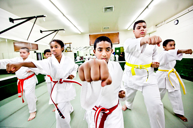 Elvis Reynoso, 9, center, does a “gyaku zuki” punch alongside Devalk Egerton, 10, left, and Axel Trinidad, 13, right, and other students in Mosholu Montefiore Community Center’s karate class.