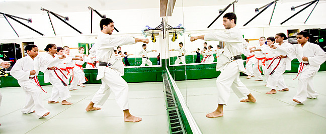 Sensei Jonas Filho, 28, above, leads his class in performing a “oi zuki” exercise.