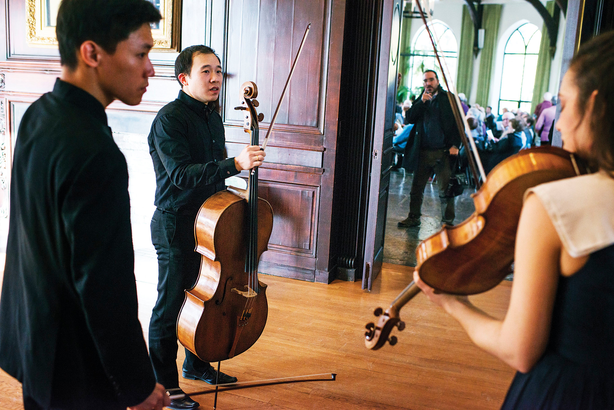 Violinist Daniel Chong, cellist Kee-Hyun Kim, and violist Jessica Bodner wait to enter the concert hall at the Wave HIll estate, before a classical performance by their group, the Parker Quartet, on Jan. 11, 2015.