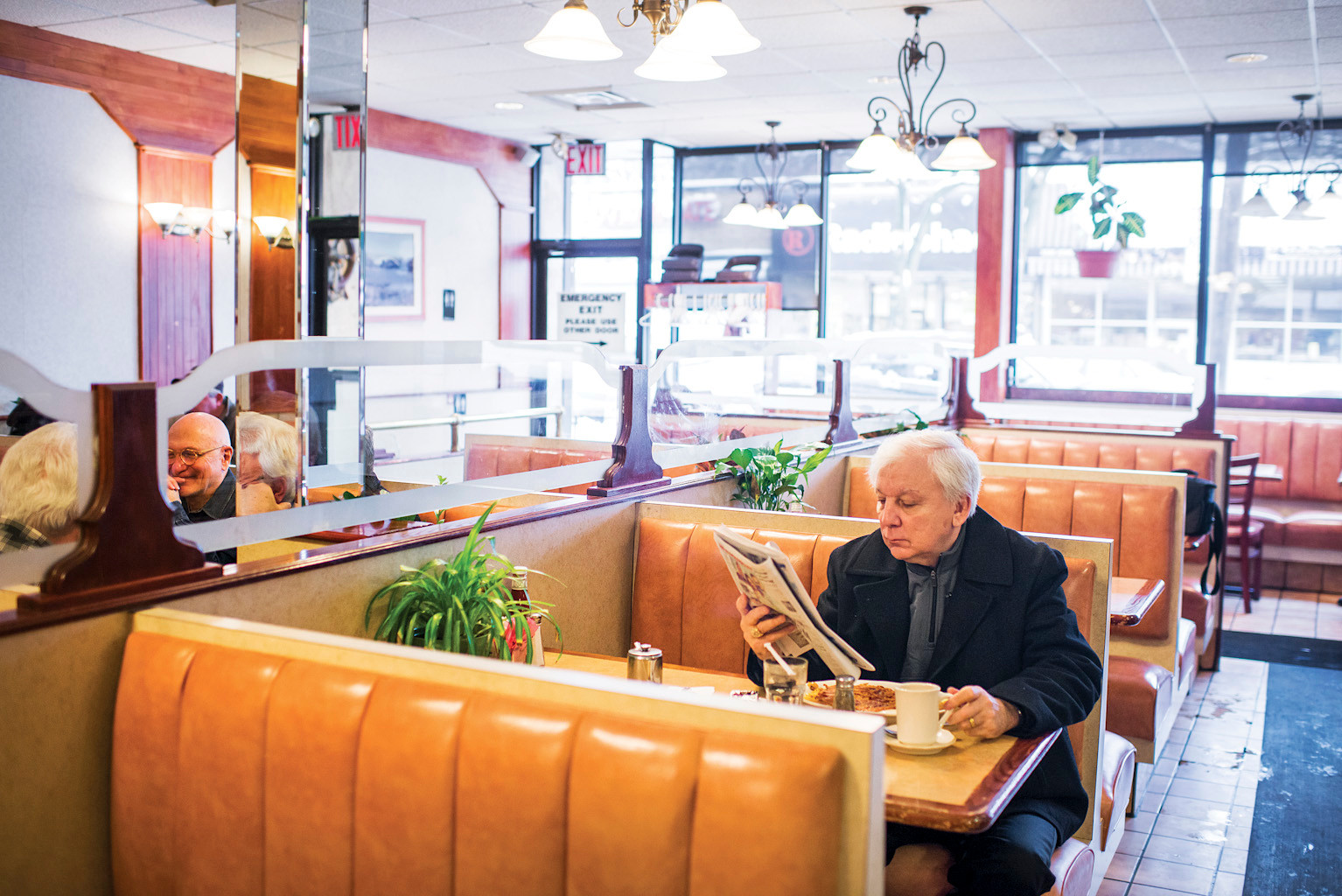 Ed Young, 68, reads the newspaper at the Blue Bay Restaurant in Riverdale.