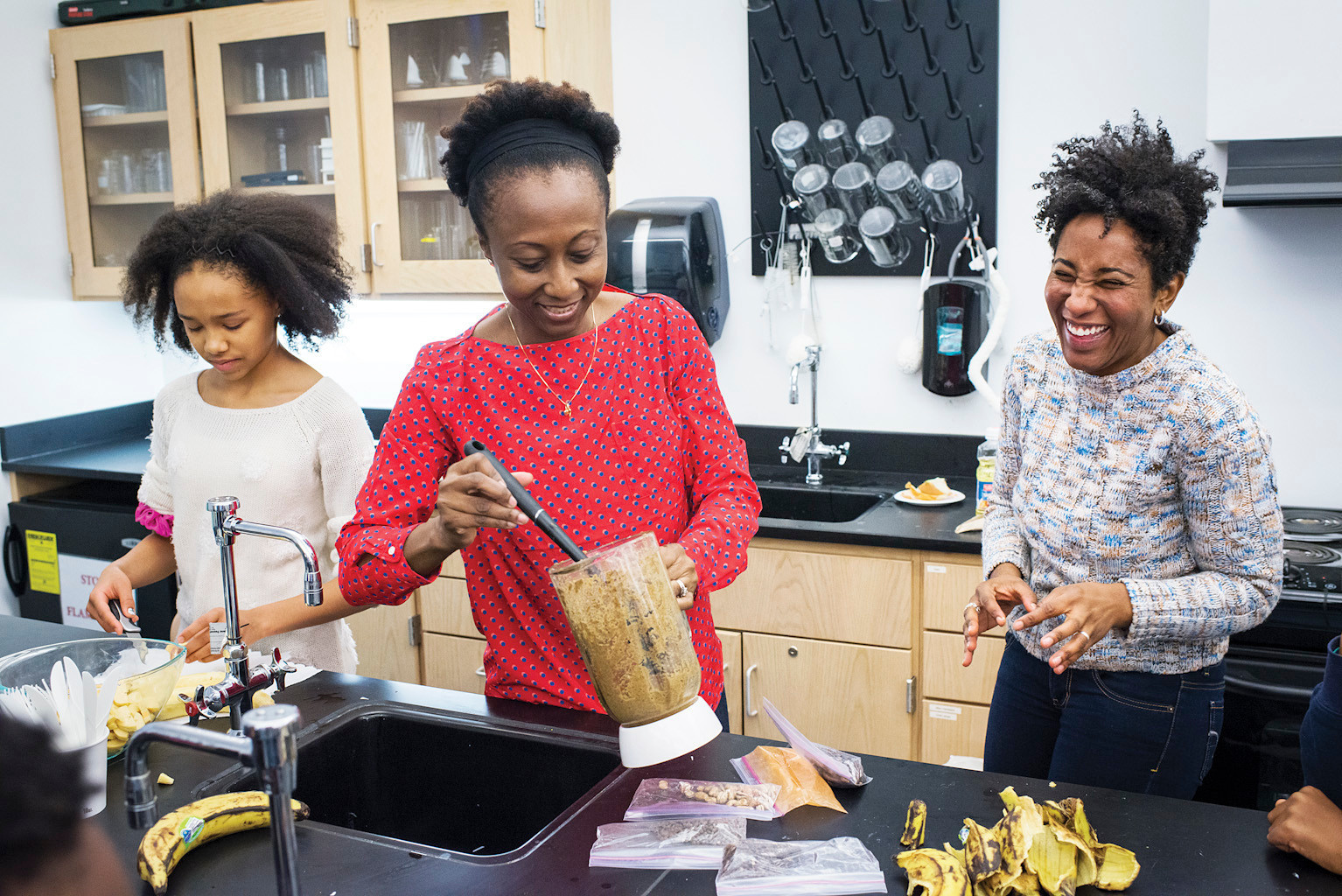 English teacher Keedra Gibba, 37, right, helps make the Ghanaian dish Kelewele with parent and native Ghanaian Julia Boahene, center, alongside eighth grader Whitney Wyche, 13, at the Ethical Culture Fieldston School on Monday.