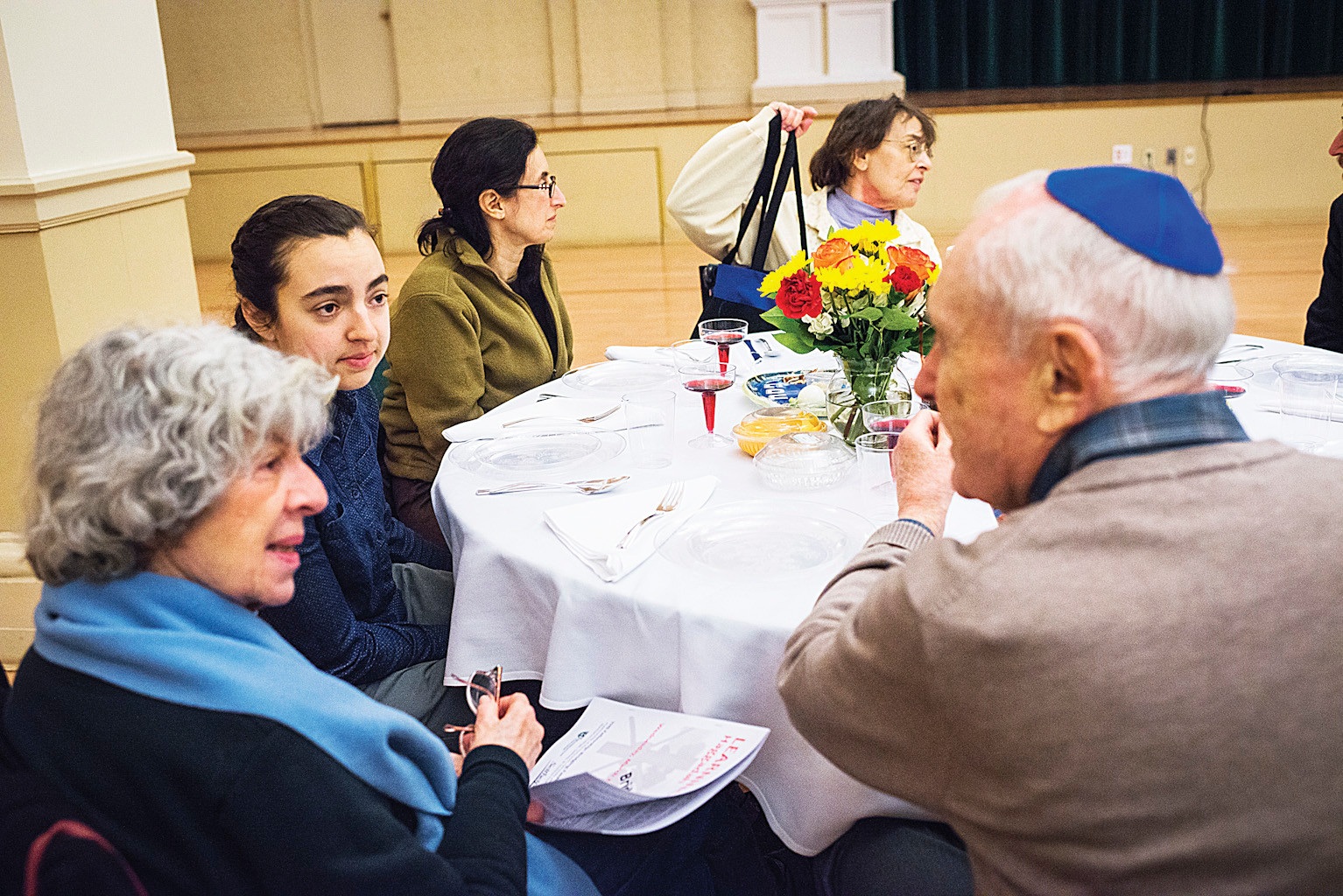 Seder attendees trade stories while at the Manhattan College celebration.