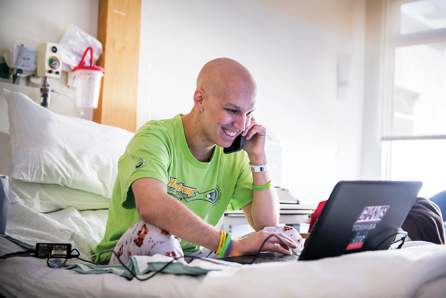 Manhattan College sports announcer Christian Heimall, 25, sits in his room in the children's wing of the Westchester Medical Center on Monday. A cancer patient, he is due to be released on April 7, after four months of treatment.