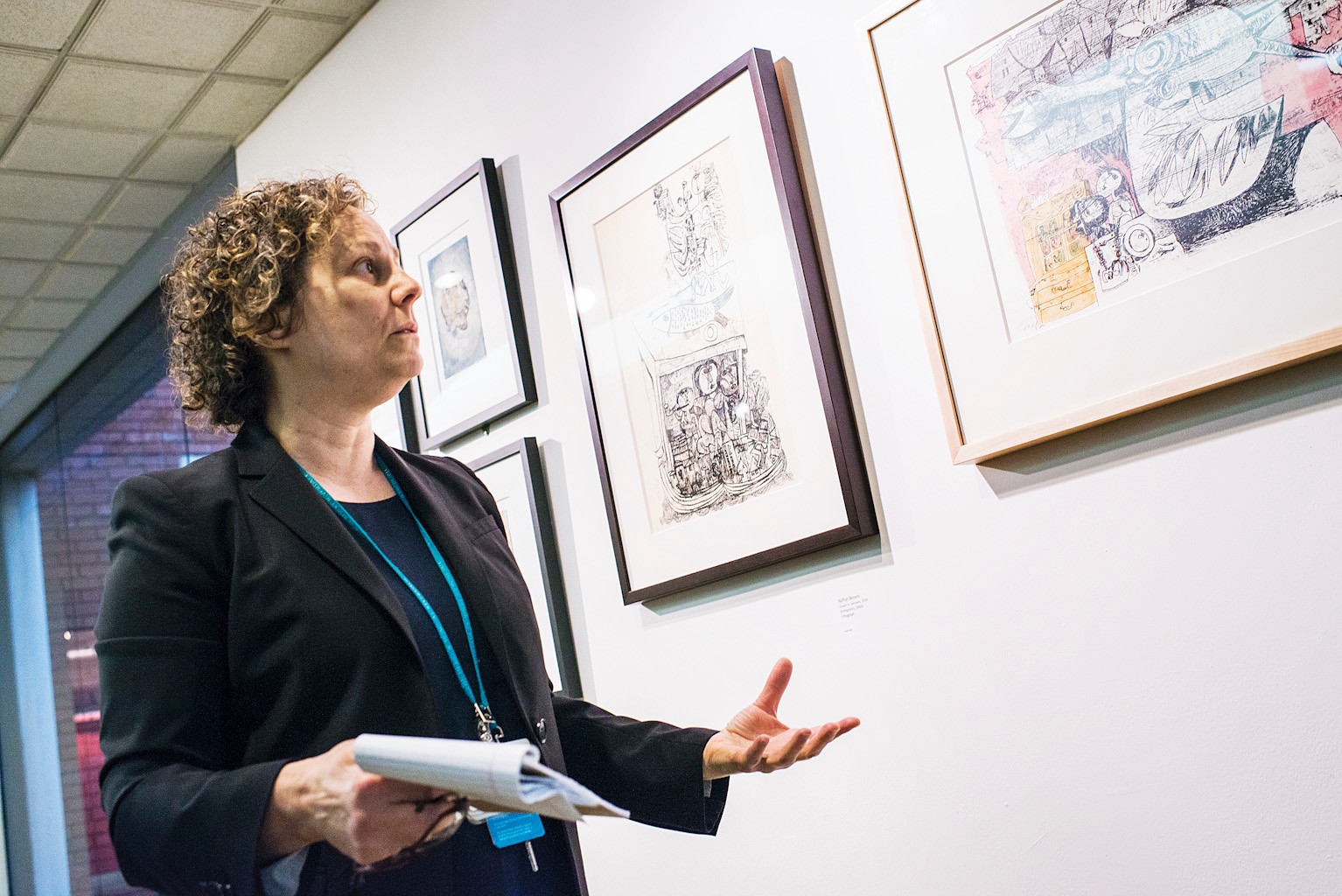 Hebrew Home museum curator Susan Chevlowe gives a tour of a new surrealist art exhibit on Monday morning.