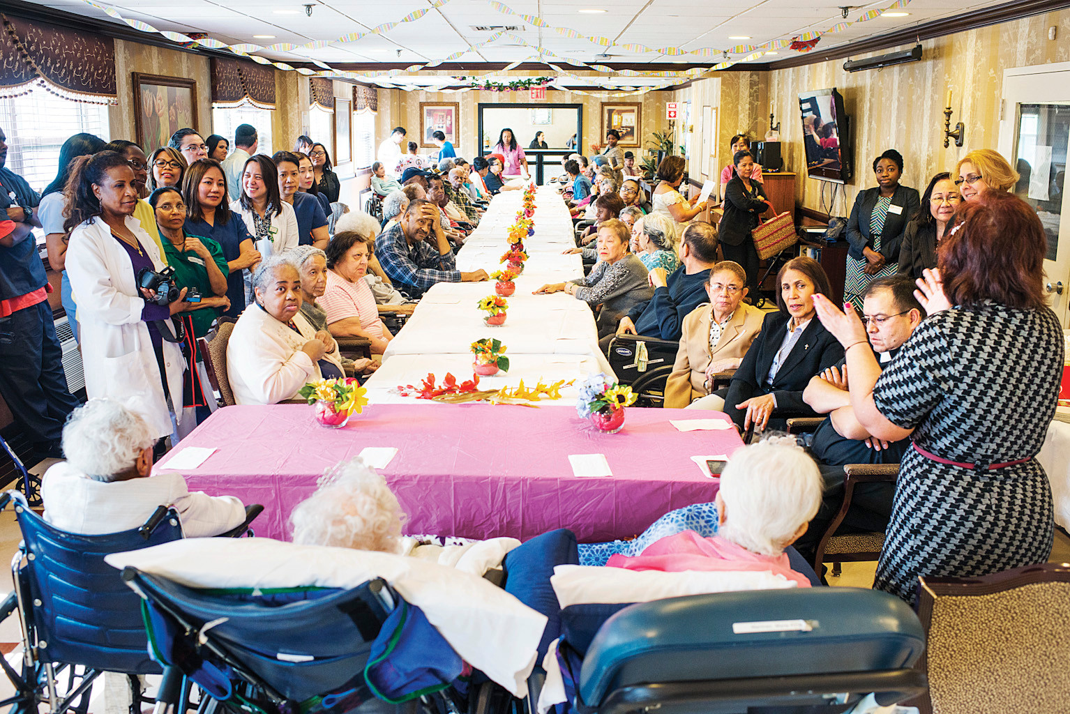 Faculty and residents gather for the birthday party of three centenarians, Carmen Benitez, 101, Bernice King, 108, and Maria Martinez, 103, in the Manhattanville Health Care center in Kingsbridge, on April 17.