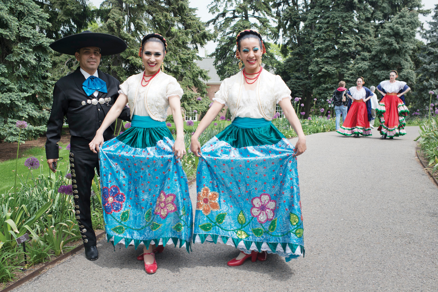 Members of the Calpulli Mexican Dance Company, based in Elmhurst, pose for a photo before running off to a performance during the 'Frida Kahlo: Art, Garden, Life' exhibit which opened for members on May 15.