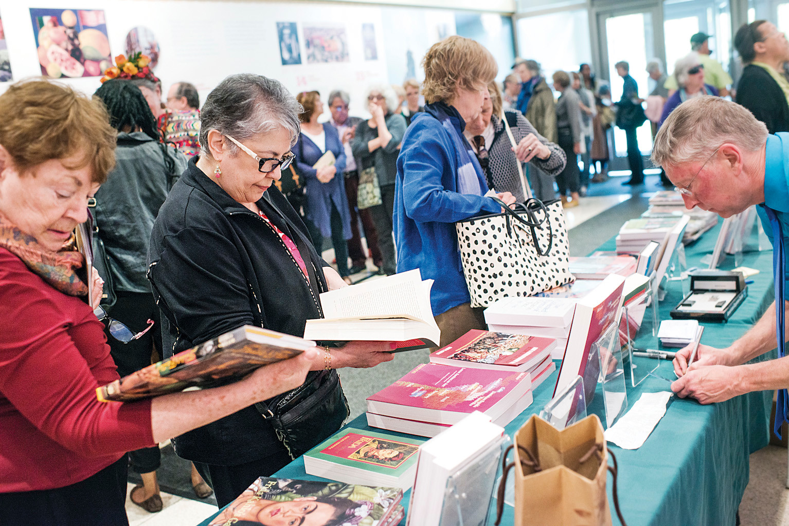 Members view the Frida Kahlo books for sale before a panel discussion on Mexican Art in the Ross Auditorium.