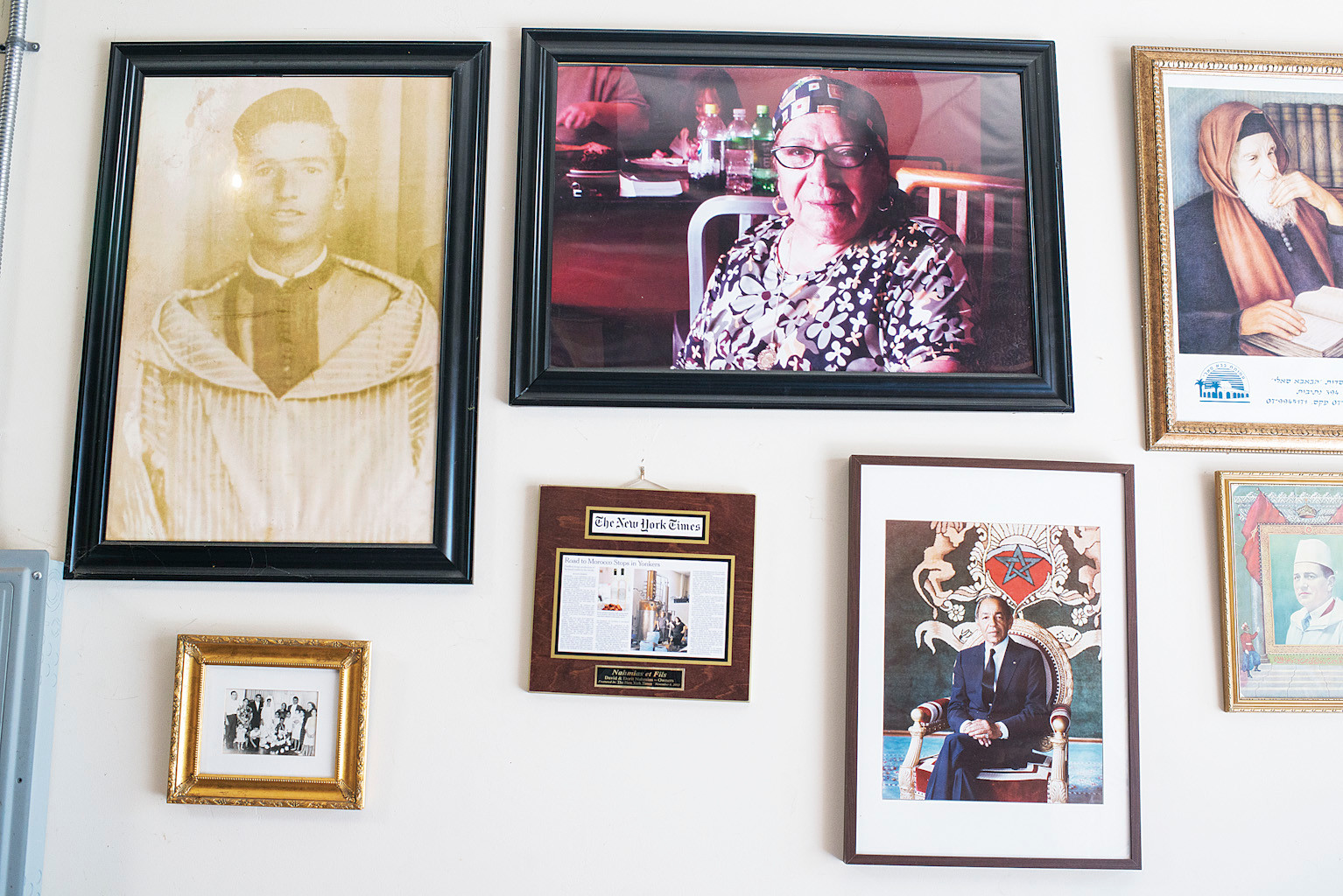 Clockwise from left: The parents of David Nahmias, Kabbalist Baba Sali, two pictures of Moroccan royalty, a news article, and a family portrait - on the wall at Nahmias et Fils.
