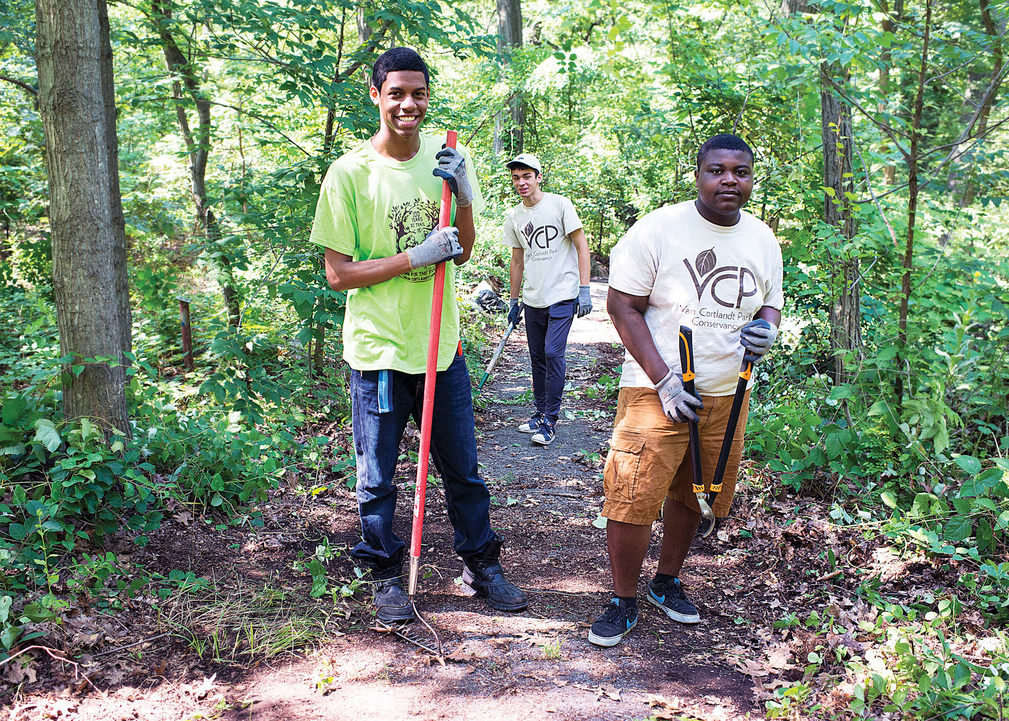 Steven Francis, Marcus Anderson, and Curtis Antiwi pose for a photo together as they clear overgrown trails in Van Cortlandt Park on July 16.