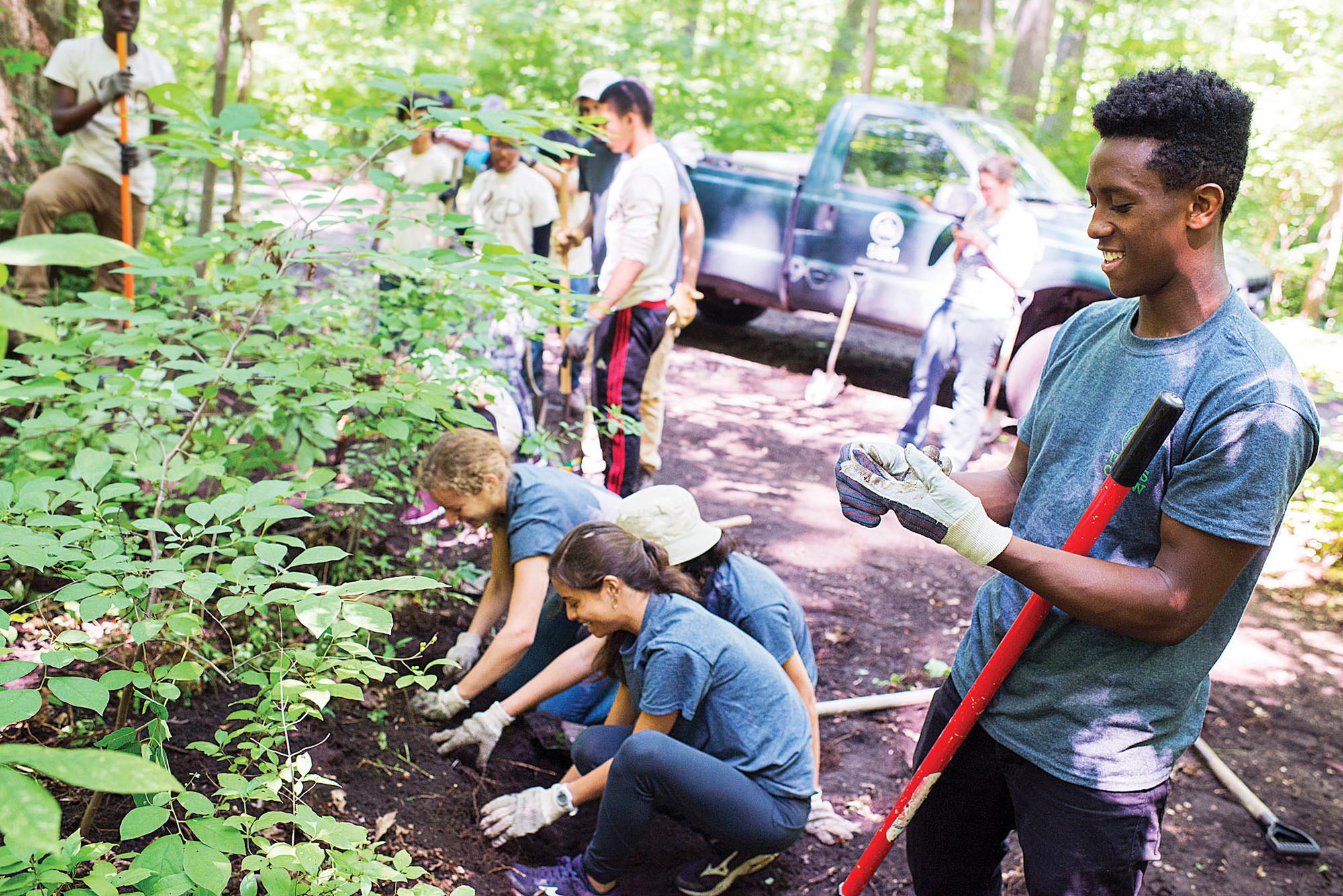 Kenyah Wiggins, a Truman High School student who lives in Coop City, helps to clear mud and weeds from an overgrown trail in Van Cortlandt Park on July 16.