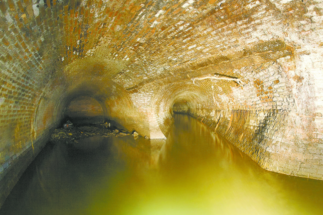 In the sewer running beneath Broadway, on the left, sewage flows in from homes and other sources. On the right, freshwater from Tibbetts Brook enters the channel.