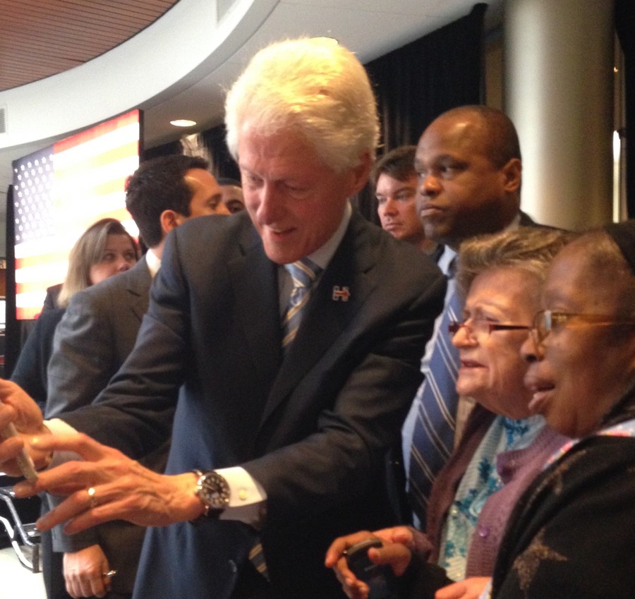 Former President Bill Clinton readies to take a selfie with Hebrew Home resident Evelyn Hannigan, 79, and staff member Robin Gibbs.