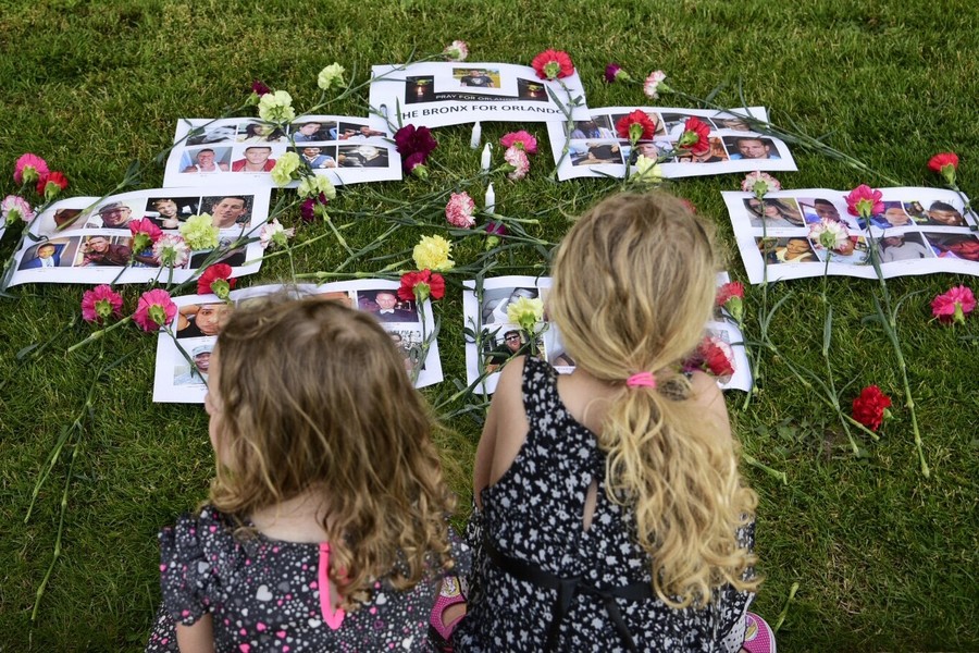 Grace and Hannah Born-Napolitano at a makeshift memorial for the victims, paces away from the vigil at the courthouse.
