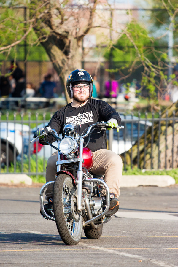 Press reporter Anthony Capote rides a Honda Rebel at the end of his introductory lesson at Motorcycle Safety School, which offers classes in the north parking lot of Lehman College.