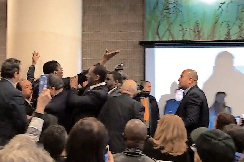 Self-proclaimed journalist and activist Sami Disu is escorted out of a speech by U.S. Rep. Adriano Espaillat after he rushed the podium. The congressman stopped security from doing so and answered Disu’s questions during the event last week at Tracey Towers.