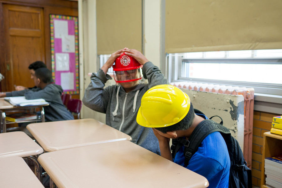 seventh-graders get into character as they take part in their last practice session for the Thurgood Marshall Mock Trial Competition. Some of the props included a police badge, firefighter’s hat and construction worker’s hat.