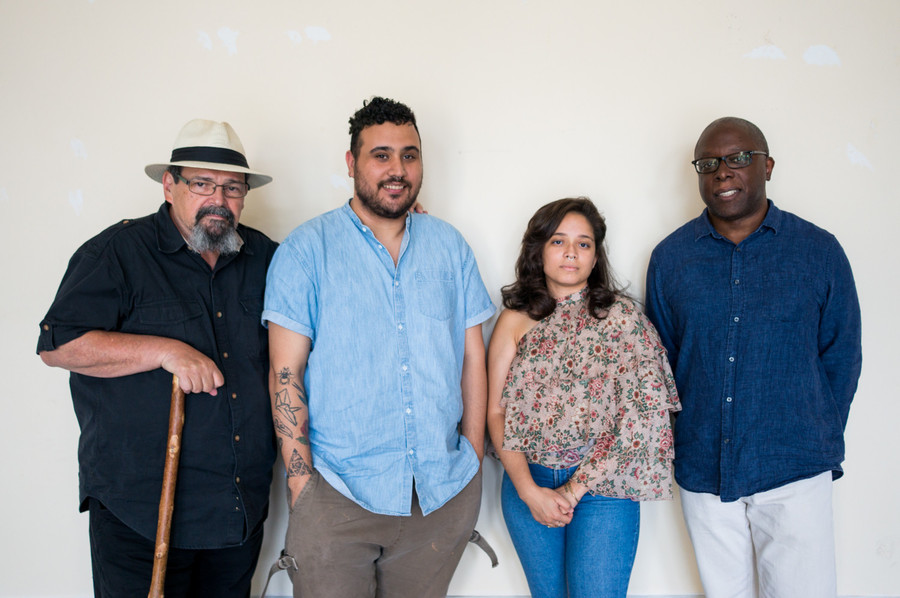 Bill Aguado, Oscar Rivera, Layza Garcia and Ron Kavanaugh stand in the Andrew Freedman Home where the Urban Arts Cooperative and En Foco are based. The four are just some of the faces backing an effort to help artists sustain financial stability and success.