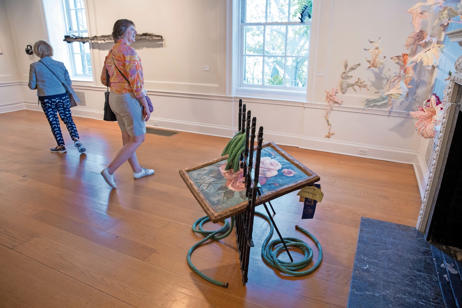 Wave Hill visitors look at works in the Glyndor Gallery. The exhibition, featuring 50 alumni artists, celebrates the 10th anniversary of the Sunroom Project Space, which invites local artists to create work related to Wave Hill. The exhibit, ‘Call & Response’ runs through Dec. 3.