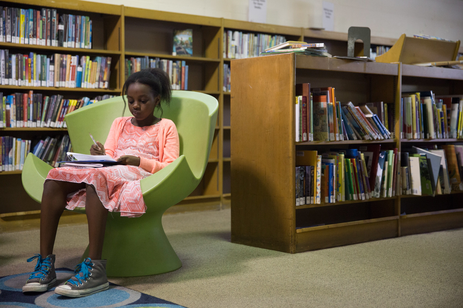 Hadasah Ndegwa, fifth-grader at P.S. 81 Robert Christen, does homework at the library.