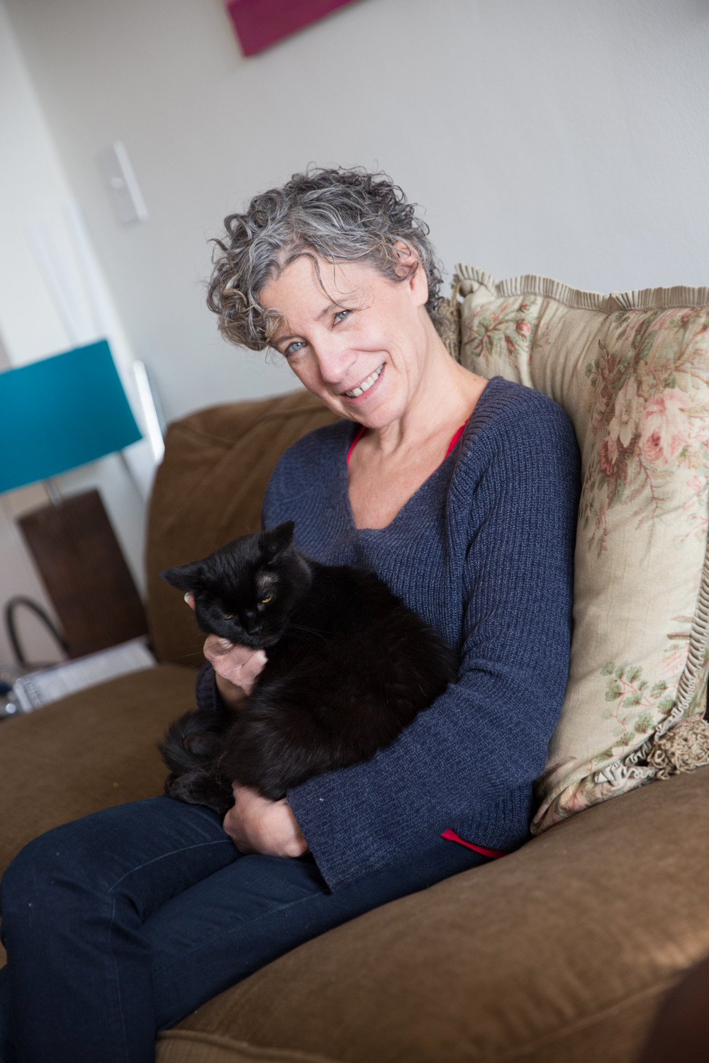 Susan Wolfe, a volunteer at the Manhattan Animal Care Center, says one of the hardest things for her is getting older cats adopted. Wolfe, here with her cat Sneaky, conceived the idea for the program Seniors 4 Seniors Cats-on-Wheels as a way to find older cats loving homes.