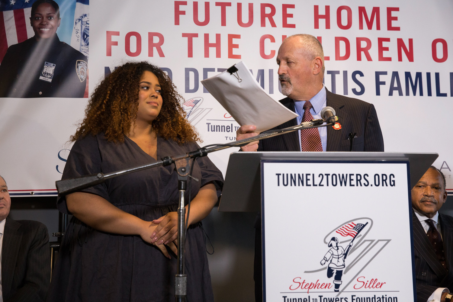 Frank Siller, chair and chief executive of Tunnels to Towers, hands Genesis Villella the signed deed to her family’s new home at Skyview-on-the-Hudson. Villella, and siblings Peter and Delilah, are the children of slain police officer Miosotis Familia.