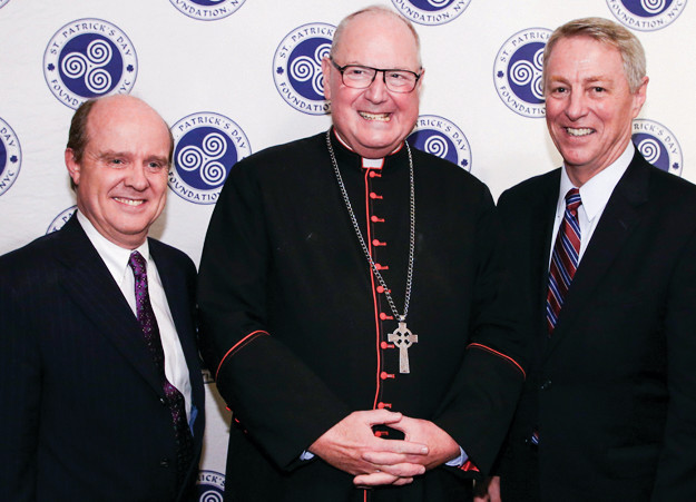 St. Patrick’s Day Foundation chair Hilary Beirne, left, Cardinal Timothy Dolan and Timothy McNiff are implementing a new scholarship program named after the cardinal that recognizes a high-performing student, an average student and a special needs student.
