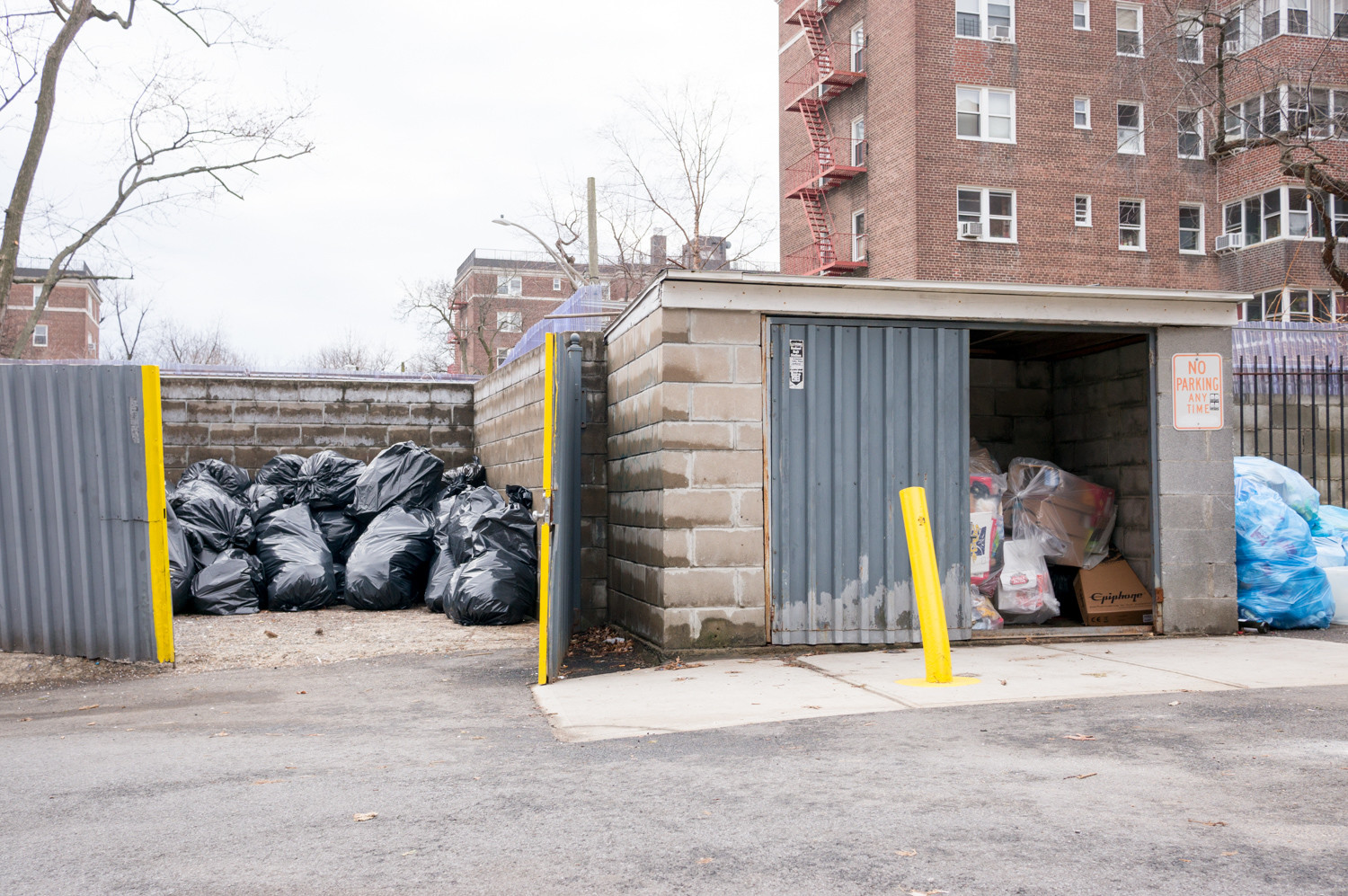 A row of dumpsters and a bleak cinderblock wall on Netherland Avenue between West 254th and West 256th streets is a major obstacle for pedestrians. But that could change if the city finally decides to add sidewalks to one side of the street.