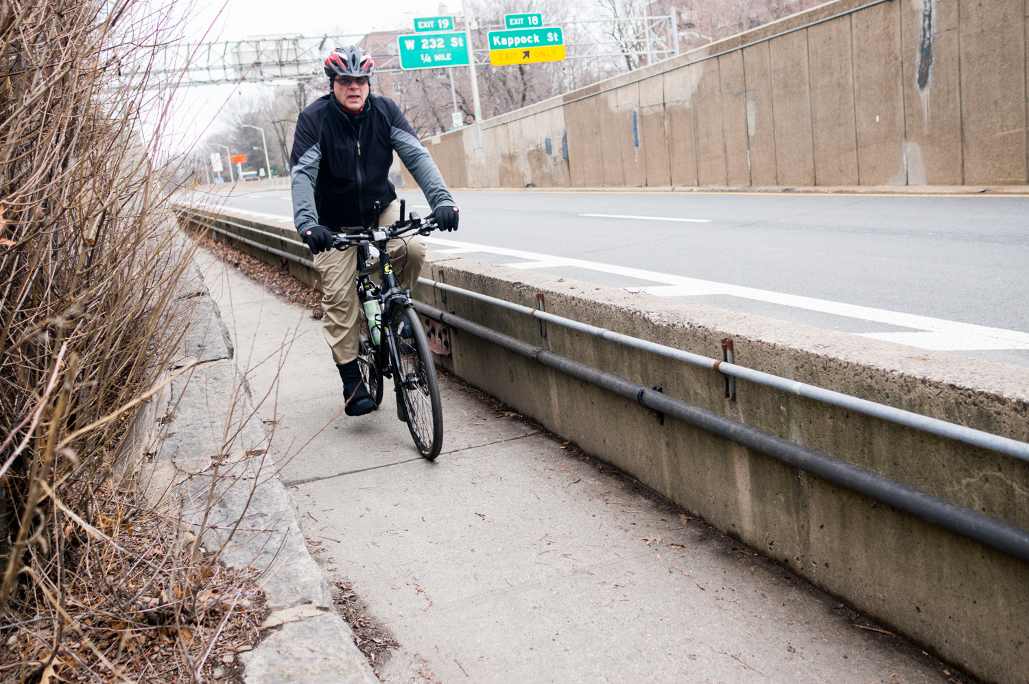 A cyclist rides his bike along the Henry Hudson Bridge's pedestrian pathway. That pathway will close starting in the spring, meaning anyone not in a car will either wait for a shuttle, or detour to other bridges.