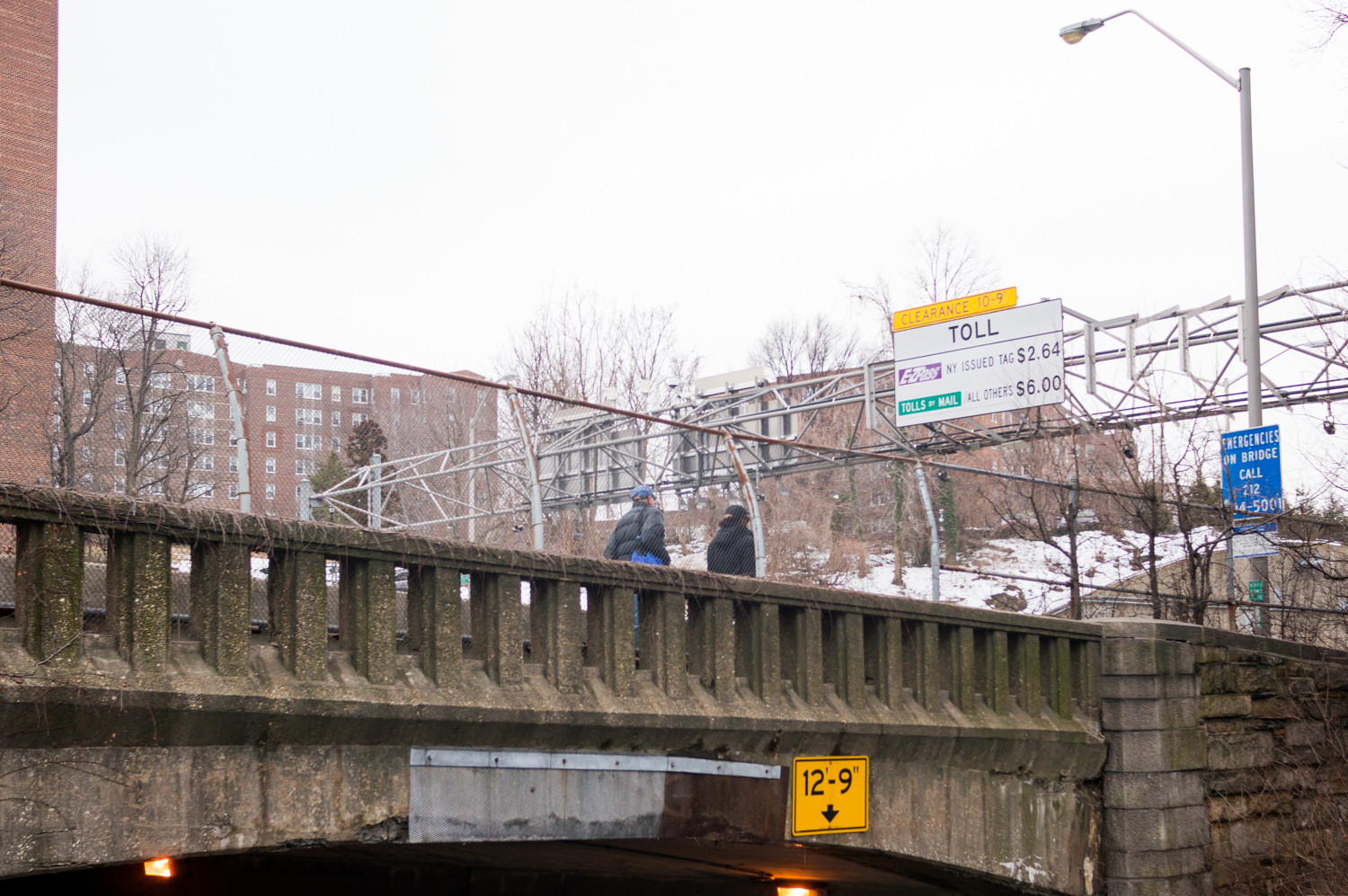 Pedestrians walk along the Henry Hudson Bridge's pedestrian pathway. Ongoing construction on the bridge will eventually shut down the pathway for months.