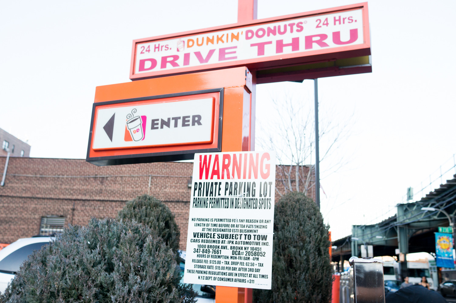A sign posted at the entrance to the Dunkin’ Donuts parking lot at West 230th Street and Broadway informs drivers their cars will be towed if they park there and go anywhere other than Dunkin’.