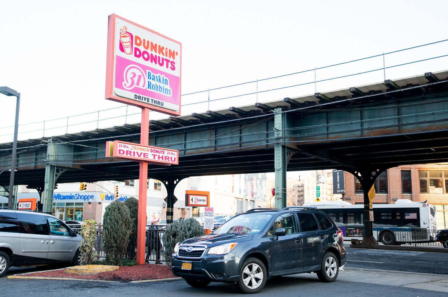 A driver looks for a spot at the Dunkin’ Donuts parking lot at West 230th Street and Broadway. Drivers are forbidden from using the lot unless they’ve come for the doughnuts and coffee — or for ice cream at the location’s Baskin-Robbins. Otherwise, they risk getting towed.