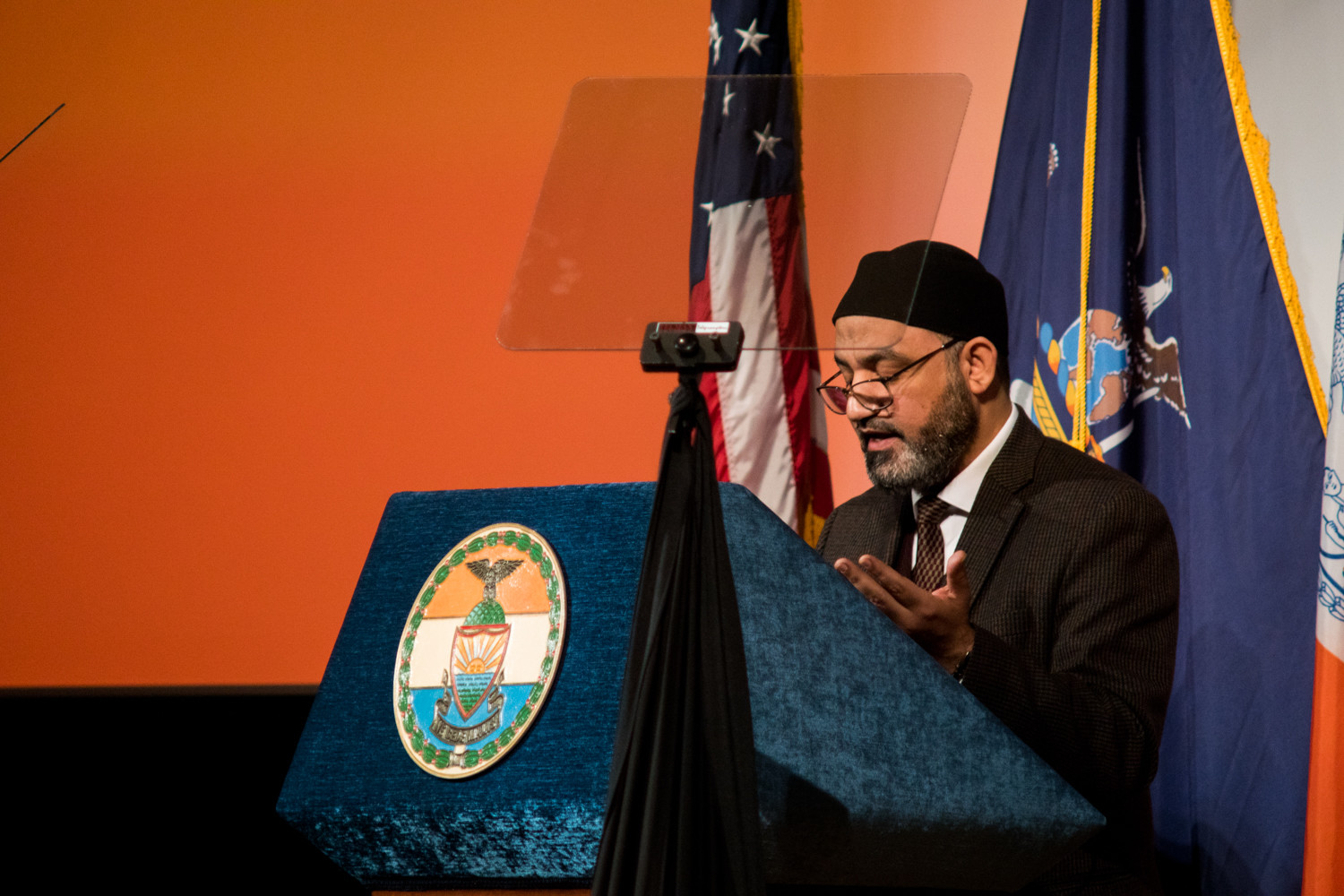 Ali Kamel, an imam at the Muslim American Society’s Upper New York subchapter, raises his hands in prayer as he gives the invocation before Ruben Diaz Jr.’s state of the borough address at the Bronx High School of Science.