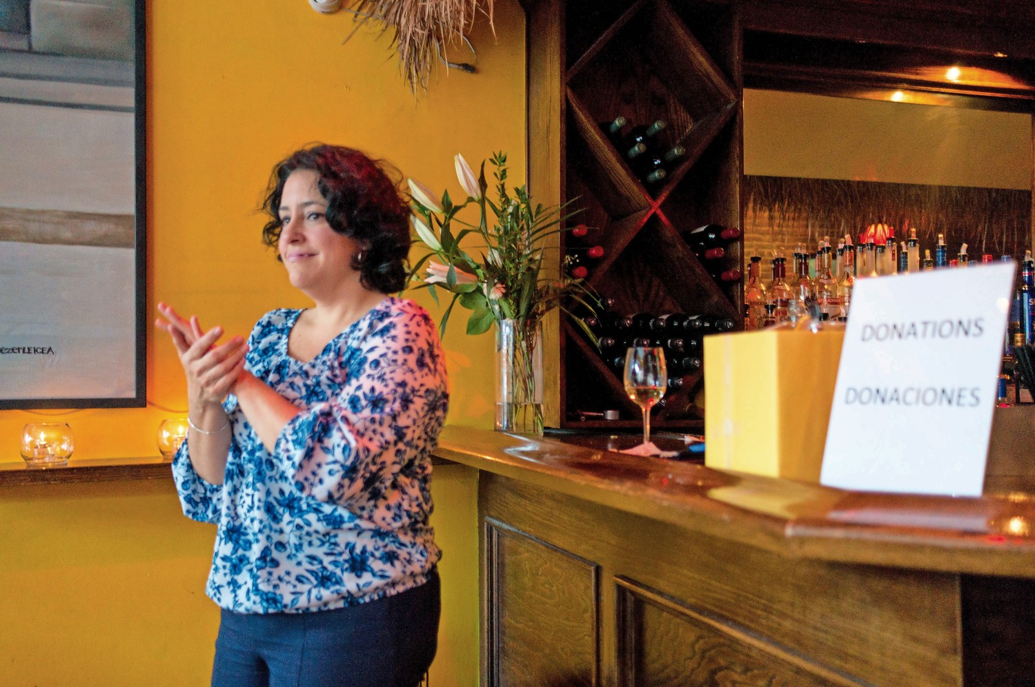 Teresita Levy, a professor of Latin American studies at Lehman College, claps along to the music of Trio La Cumbancha at Amor Cubano, a Cuban restaurant in Harlem. Levy held a fundraiser at the restaurant for a weeklong trip she and her students are planning as part of their coursework.
