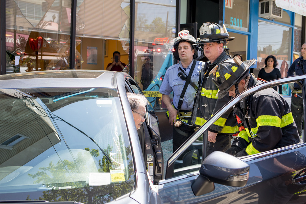 The fire and police departments respond to an accident where a car crashed into the Kumon Math and Reading Center's North Riverdale location near West 259th Street around lunchtime May 9. Police reported no injuries.