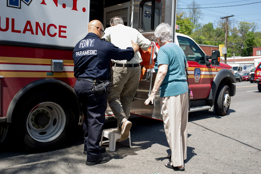 A paramedic helps the 82-year-old driver of a Subaru that plowed into the North Riverdale Kumon Math and Reading Center May 9 into an ambulance. The driver narrowly missed instructor Claire Kim, who said she’d stepped outside to check the mail right when the Subaru slammed into her storefront.
