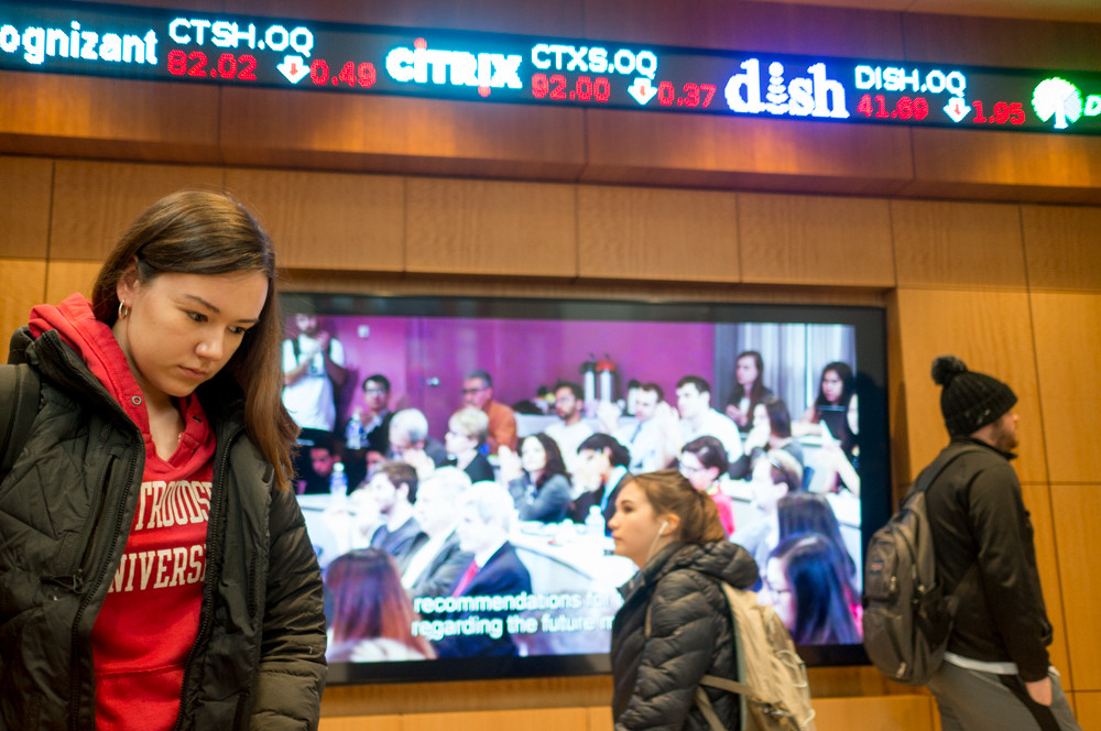 Manhattan College students walk by the stock ticker between classes at the O'Malley School of Business De La Salle Hall. The school gets a new dean in July — Don Gibson.