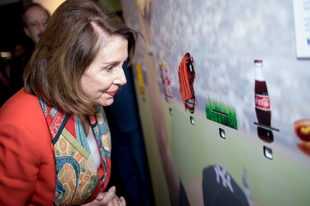 JULIUS CONSTANTINE MOTAL
Former House Speaker Nancy Pelosi takes a whiff of grass from Yankee Stadium at 'Scents of the Game,' an olfactory exhibit at the Hebrew Home at Riverdale. Pelosi toured the Palisade Avenue facility Monday with U.S. Rep. Eliot Engel.